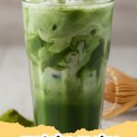 matcha recipe - A perfectly frothed hot matcha latte in a ceramic mug on a wooden table, with a bamboo whisk and matcha tin in the background.