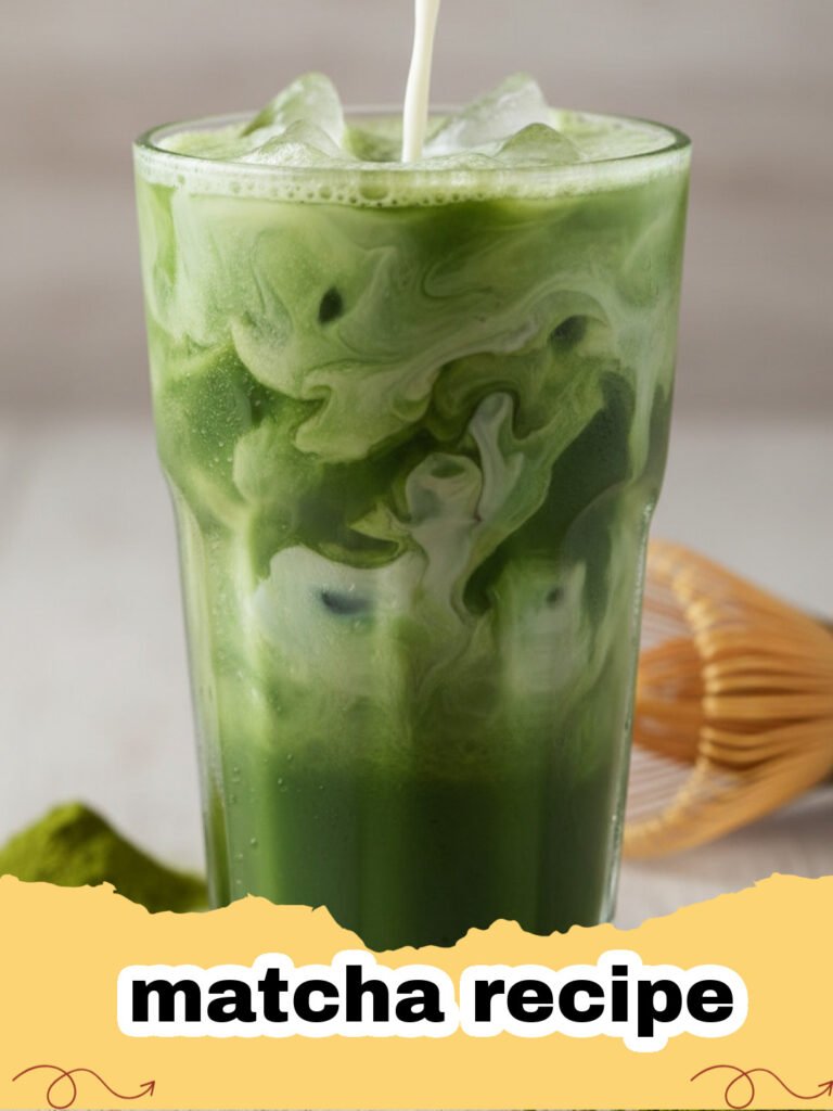 matcha recipe - A perfectly frothed hot matcha latte in a ceramic mug on a wooden table, with a bamboo whisk and matcha tin in the background.