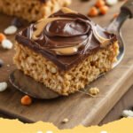 scotcharoos recipe - Close-up of freshly cut scotcharoos with a glossy chocolate and butterscotch topping, showing the crispy rice cereal base.