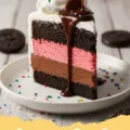 ice cream cake recipe - A beautifully layered homemade ice cream cake with chocolate and vanilla ice cream, Oreo crust, hot fudge, caramel, and whipped topping.