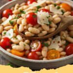 cannellini beans recipes - A rustic bowl of Tuscan white bean and sage stew, garnished with fresh parsley and a drizzle of olive oil, served with crusty bread.