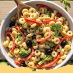 summer pasta salad recipes cold - A large glass bowl filled with colorful Zesty Italian Summer Pasta Salad including tomatoes, peppers, and mozzarella pearls.