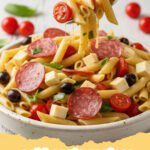 cold pasta recipes - Close-up of a vibrant Zesty Mediterranean Cold Pasta Salad in a large serving bowl, garnished with fresh herbs and feta.