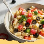 summer pasta salad recipes cold - A colorful bowl of Zesty Mediterranean Cold Pasta Salad with fresh vegetables and feta.