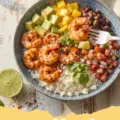 summer shrimp recipes - Platter of zesty garlic herb grilled shrimp skewers garnished with fresh parsley and lemon wedges.