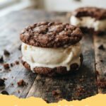 ice cream sandwich recipe - Close-up of a homemade ice cream sandwich with rich chocolate cookies and vanilla ice cream, garnished with sprinkles.