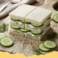 cucumber sandwiches recipes - A platter of perfectly cut classic cucumber sandwiches with visible fresh dill and chives, arranged elegantly.