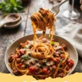 spaghetti sauce recipe - A rich, simmering pot of homemade spaghetti sauce with fresh basil leaves.
