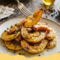 Creamy Roasted Crookneck Squash dish in a ceramic bowl, garnished with fresh herbs, ready to be served. Ideal for crookneck squash recipes.
