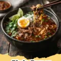 A steaming bowl of Birria Ramen with tender beef, rich red consommé, noodles, cilantro, and lime wedges