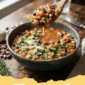 15 bean soup recipe - A steaming bowl of hearty 15 bean soup with smoked ham and fresh herbs.