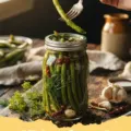 pickled green beans recipe - Several glass jars of homemade pickled green beans with dill and garlic