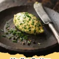 A log of homemade Vodka Butter garnished with fresh herbs, ready to be sliced and used.