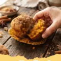 pumpkin muffin recipe - Close-up of golden-brown pumpkin muffins with streusel topping on a cooling rack.