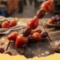 Close-up of Tanghulu (Candied Fruit Skewers) with glossy sugar coating on strawberries and grapes