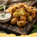 fried okra recipe - Close-up of golden brown, crispy fried okra piled on a plate, garnished with fresh parsley.