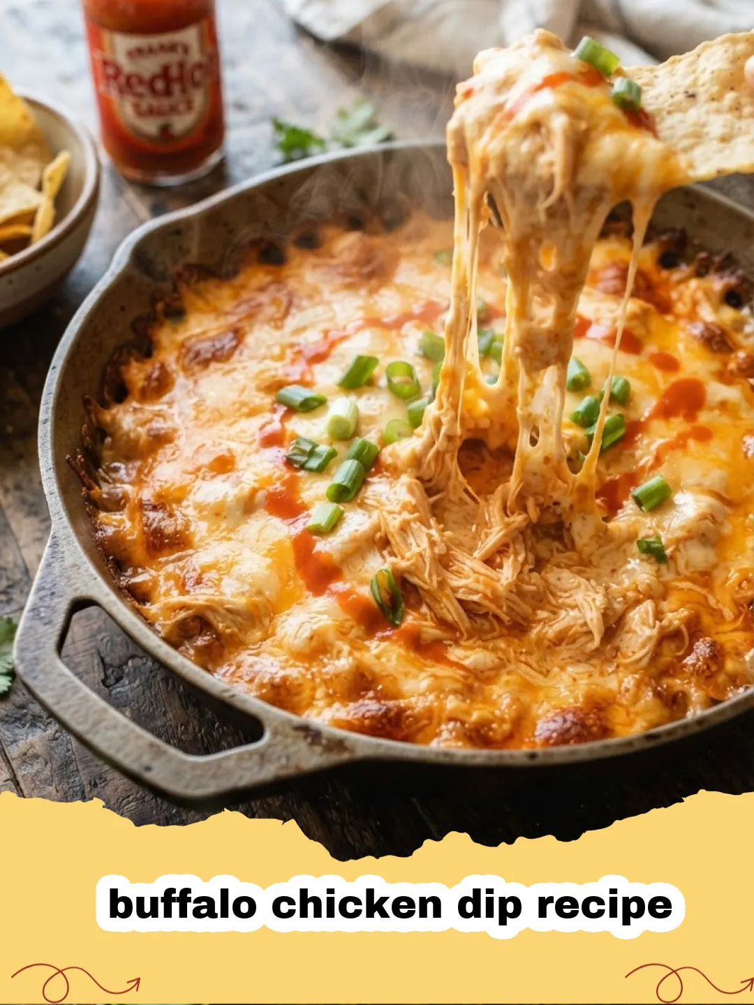 buffalo chicken dip recipe - Cheesy, bubbly buffalo chicken dip in a baking dish, garnished with green onions, with tortilla chips and celery sticks around it.