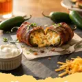 jalapeno poppers recipe - Close-up of crispy, bacon-wrapped jalapeño poppers filled with creamy cheese, served on a platter.