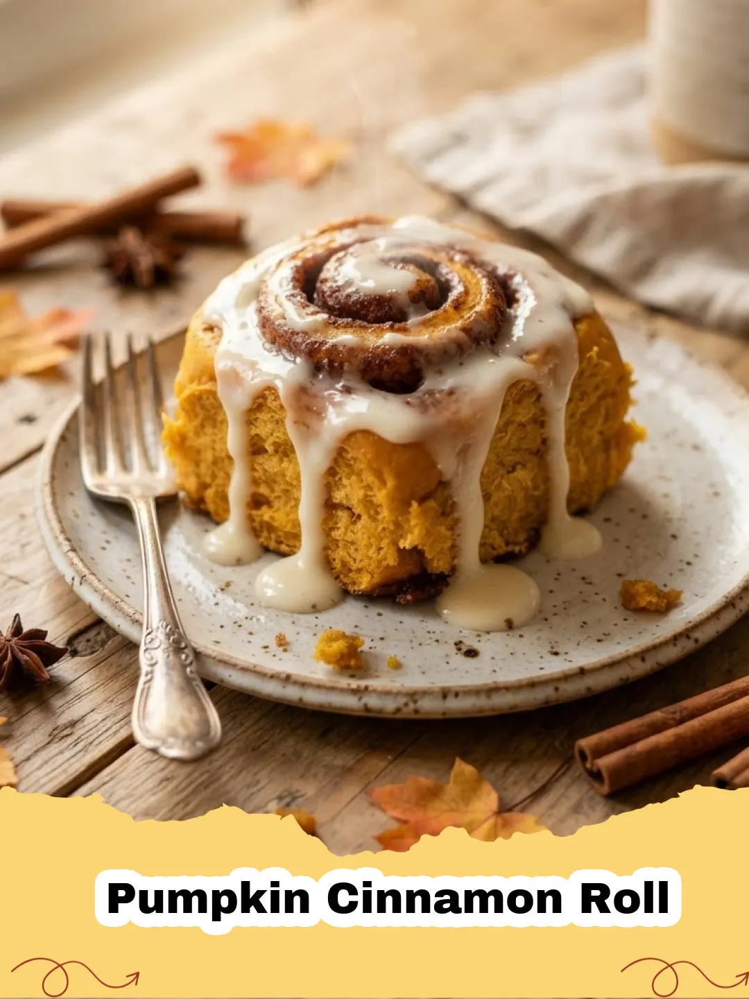 Pumpkin Cinnamon Roll - Close-up of freshly baked homemade pumpkin cinnamon rolls with cream cheese frosting, in a baking dish.