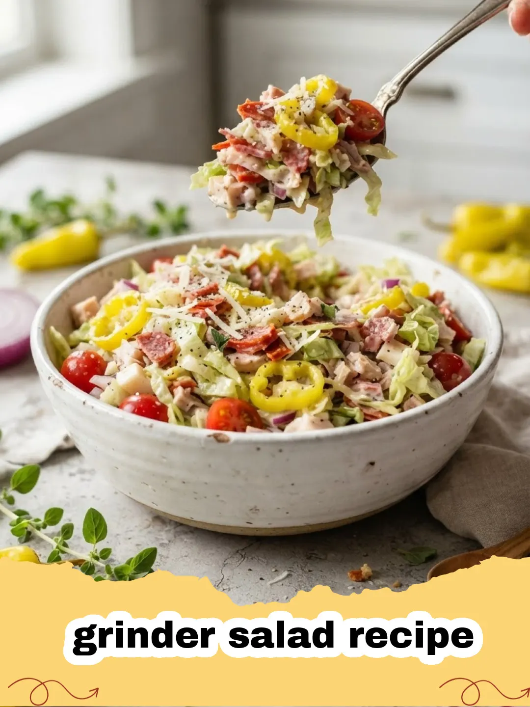 grinder salad recipe - A vibrant and crunchy grinder salad with lettuce, deli meats, cheese, and a creamy dressing in a large bowl.