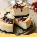 A perfectly baked, golden-brown Viral Japanese Yogurt Cheesecake with a cloud-like texture, garnished with fresh berries and a dusting of powdered sugar.