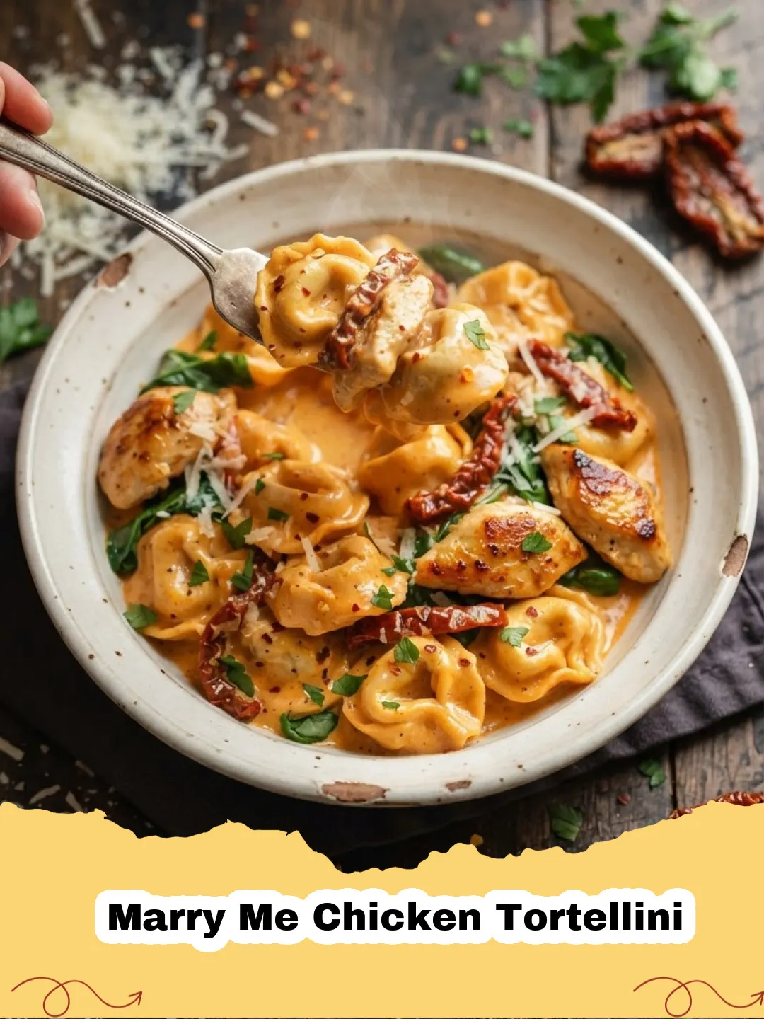 Close-up of creamy Marry Me Chicken Tortellini with sun-dried tomatoes and basil in a skillet.