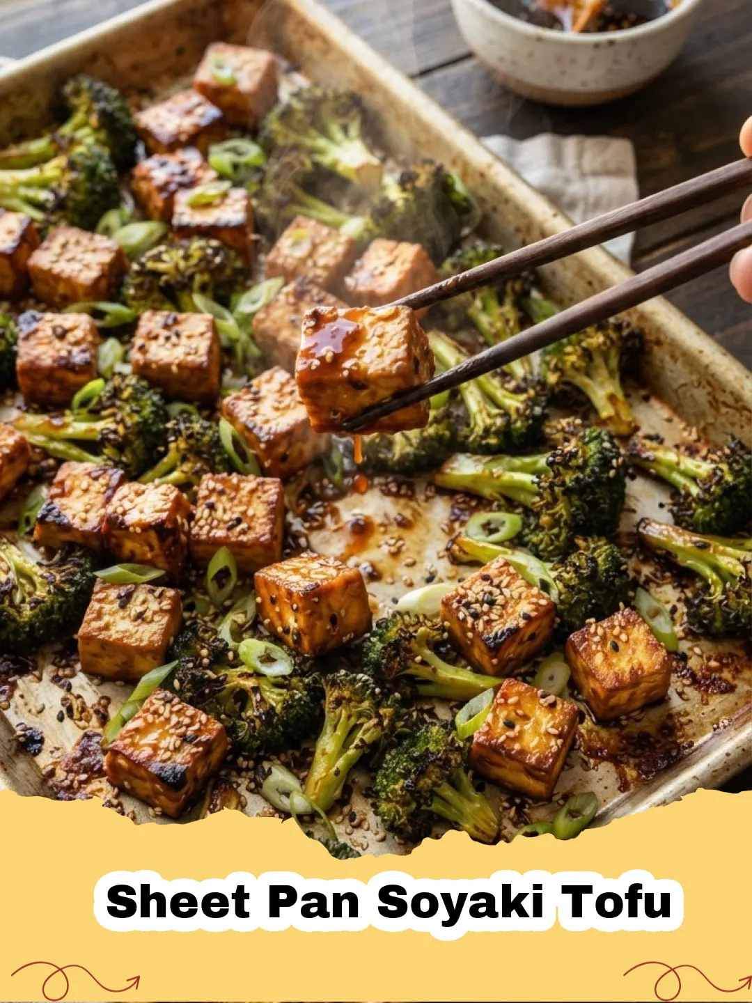 Sheet Pan Soyaki Tofu with broccoli and bell peppers, garnished with sesame seeds and green onions, served with rice.