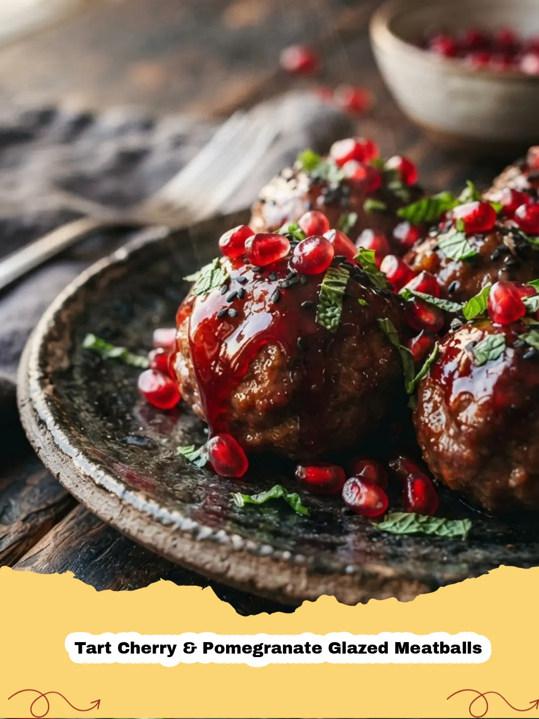 Close-up of Tart Cherry & Pomegranate Glazed Meatballs garnished with fresh parsley on a white platter, with a serving spoon.